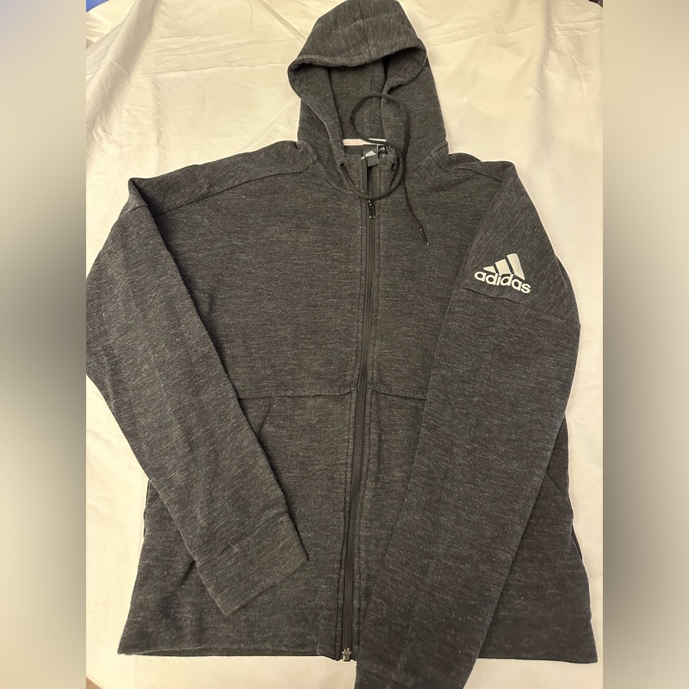 Adidas sweatshirt with hood. It’s dark gray.